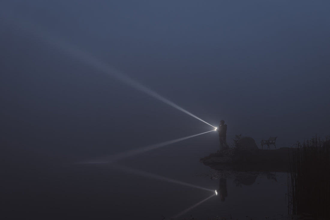 A foggy night with a person standing on a dock