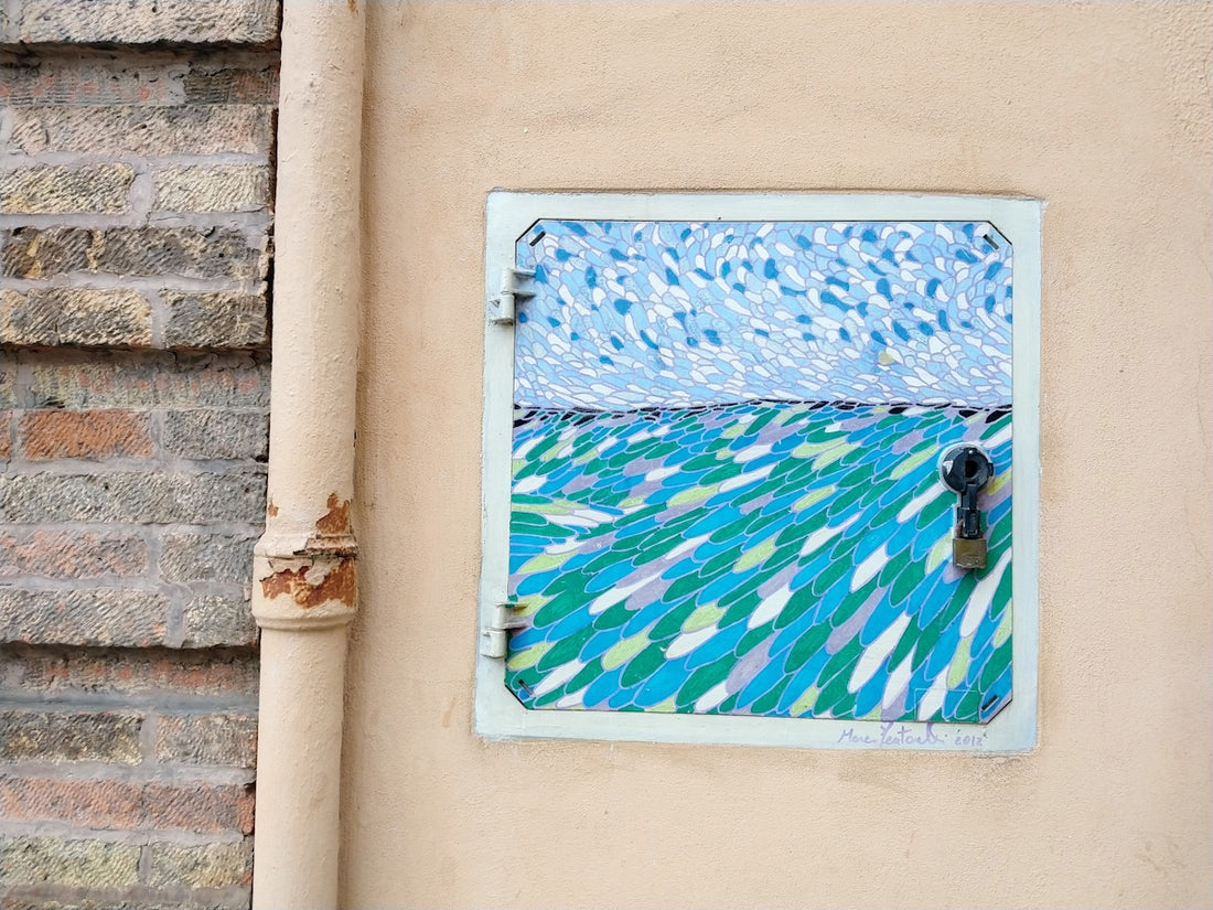 Artwork of a sea scene is painted on a wall.