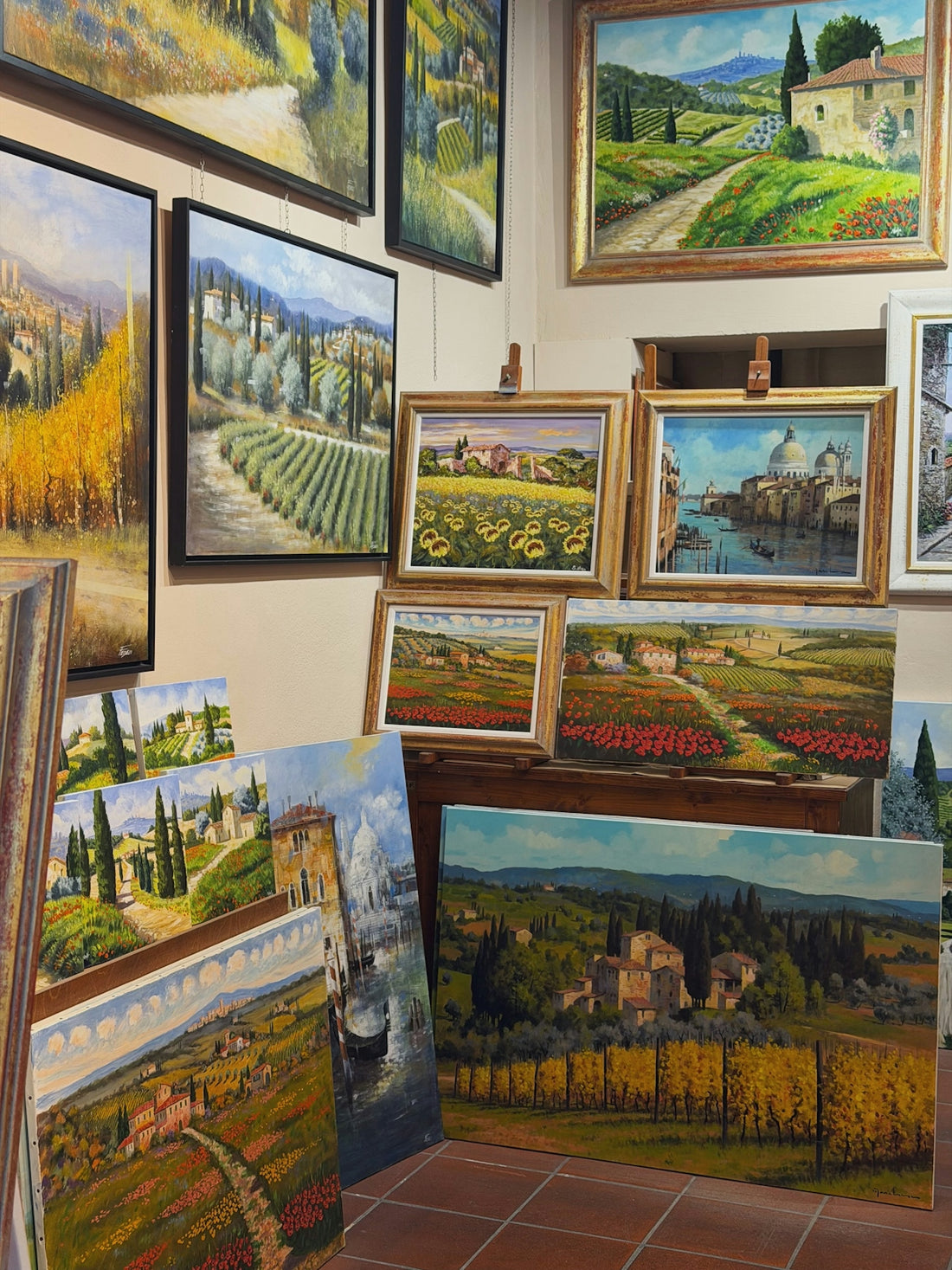 Collection of landscape paintings displayed indoors